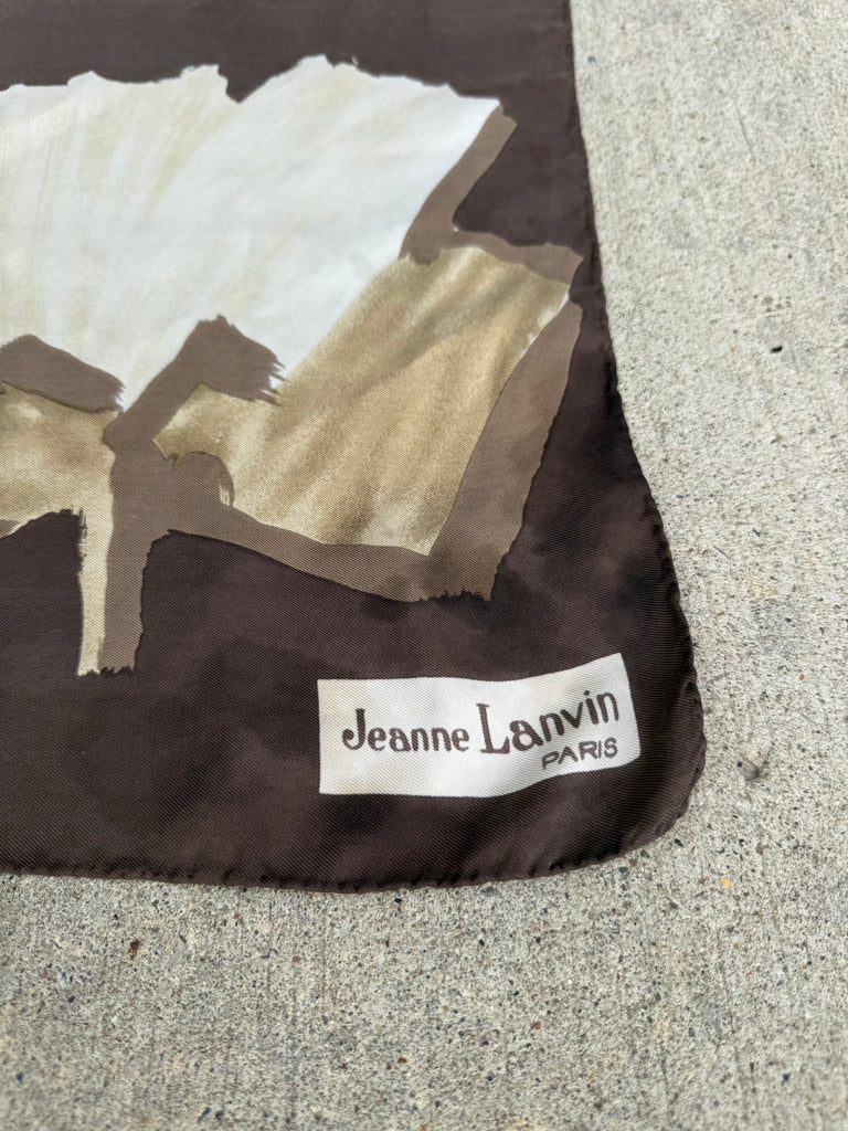 Close-up of vintage Jeanne Lanvin Paris silk scarf showing designer label and floral print