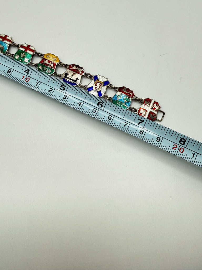 Vintage Canadian sterling silver enamel bracelet shown beside measuring tape at approximately 7.5 inches