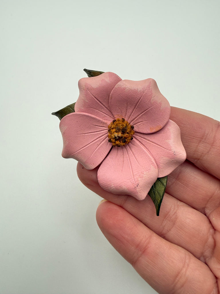 Vintage Alberta Wild Rose pink leather floral brooch shown in hand for scale