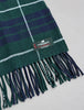 Close-up of green and navy Lochcarron Scottish tartan scarf showing fringed ends and highlander label