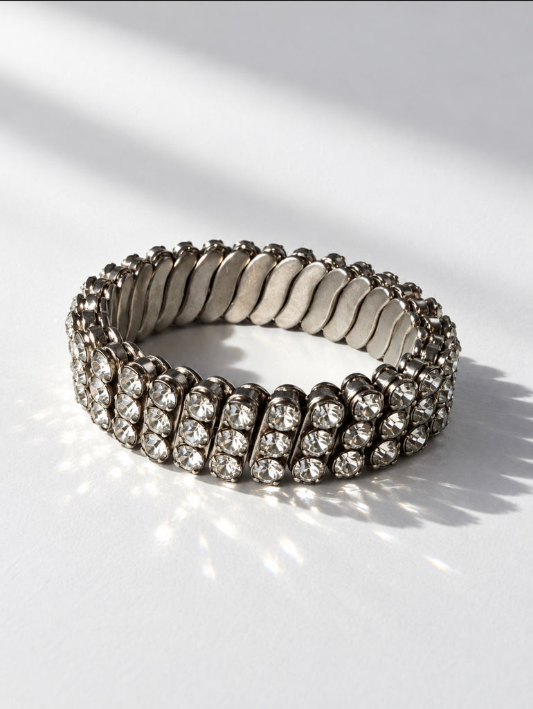 Front view of silver-tone rhinestone stretch bracelet with three sparkling rows
