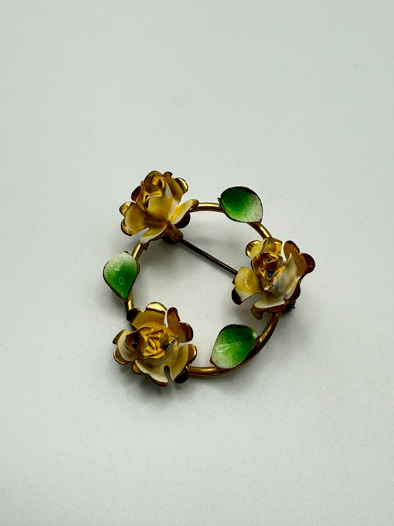 Vintage floral wreath brooch with three yellow roses and green enamel leaves