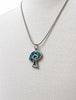 Vintage turquoise pendant necklace displayed on mannequin