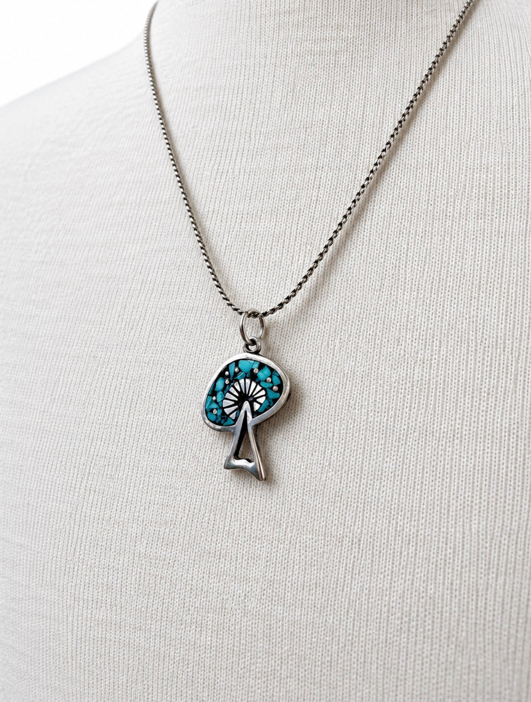 Vintage turquoise pendant necklace displayed on mannequin