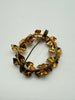 Back view of vintage Austrian wreath brooch showing gold-tone metal construction and pin closure