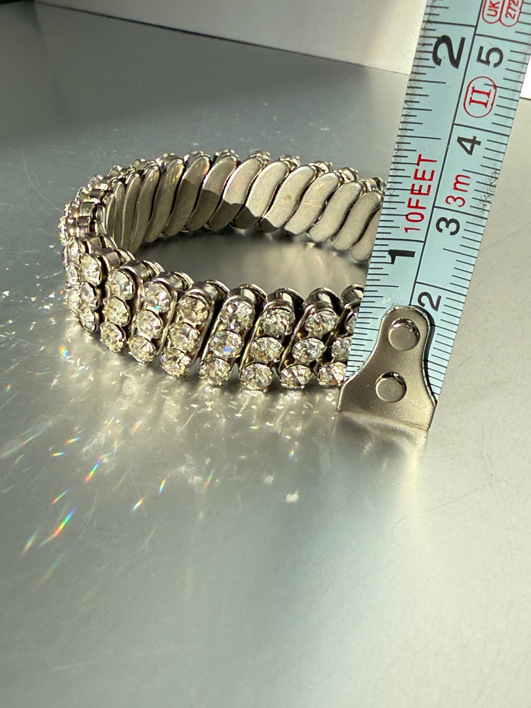 Close-up of flexible silver-tone expansion bracelet showing inner metal links