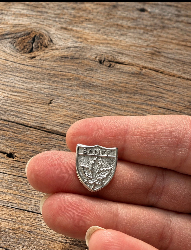Small vintage Banff sterling silver maple leaf brooch shown in hand for scale