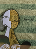 Close-up of Picasso Cubist-style figurative artwork on vintage green scarf. 