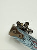 Vintage floral screw back earring beside measuring tape showing approximately 2 cm width