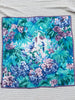 Vintage Liberty of London silk scarf with turquoise, teal, blue and purple floral bird print displayed fully open.