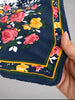 Vintage navy floral silk scarf showing colourful border and hand-rolled edge