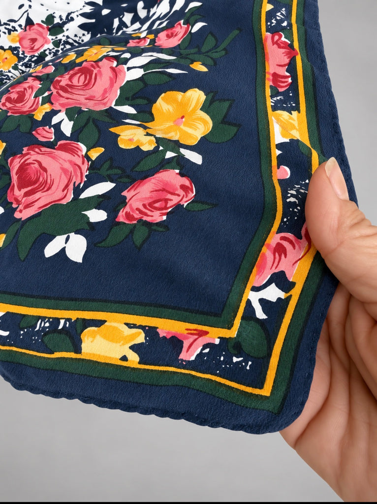 Vintage navy floral silk scarf showing colourful border and hand-rolled edge