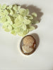 Vintage shell cameo brooch with woman profile and floral detail in gold-filled frame