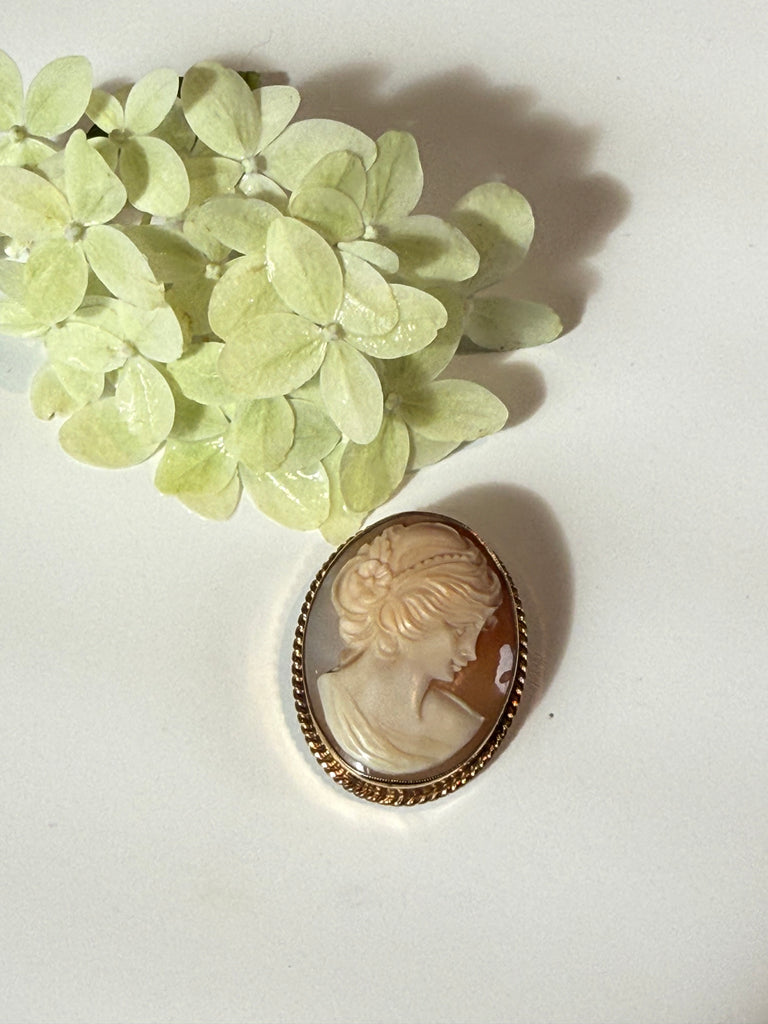 Vintage shell cameo brooch with woman profile and floral detail in gold-filled frame