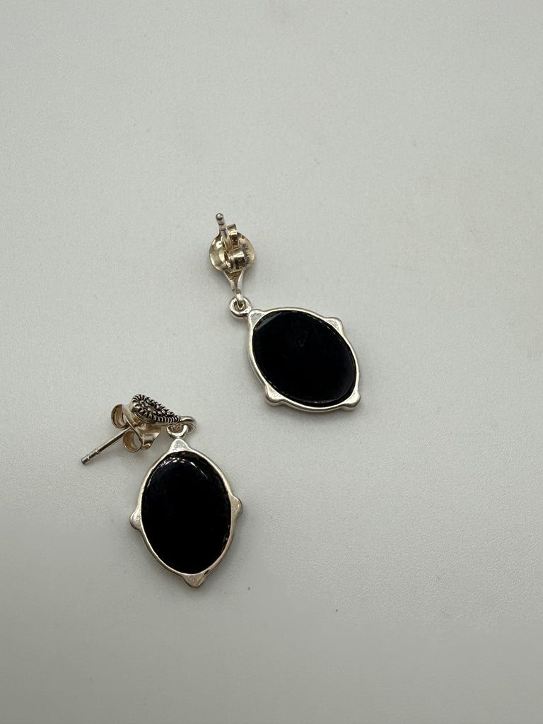 Back of vintage 925 silver drop earrings showing pierced posts and butterfly backs