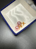 Back view of vintage pink faux pearl earrings showing gold-tone posts and butterfly backs
