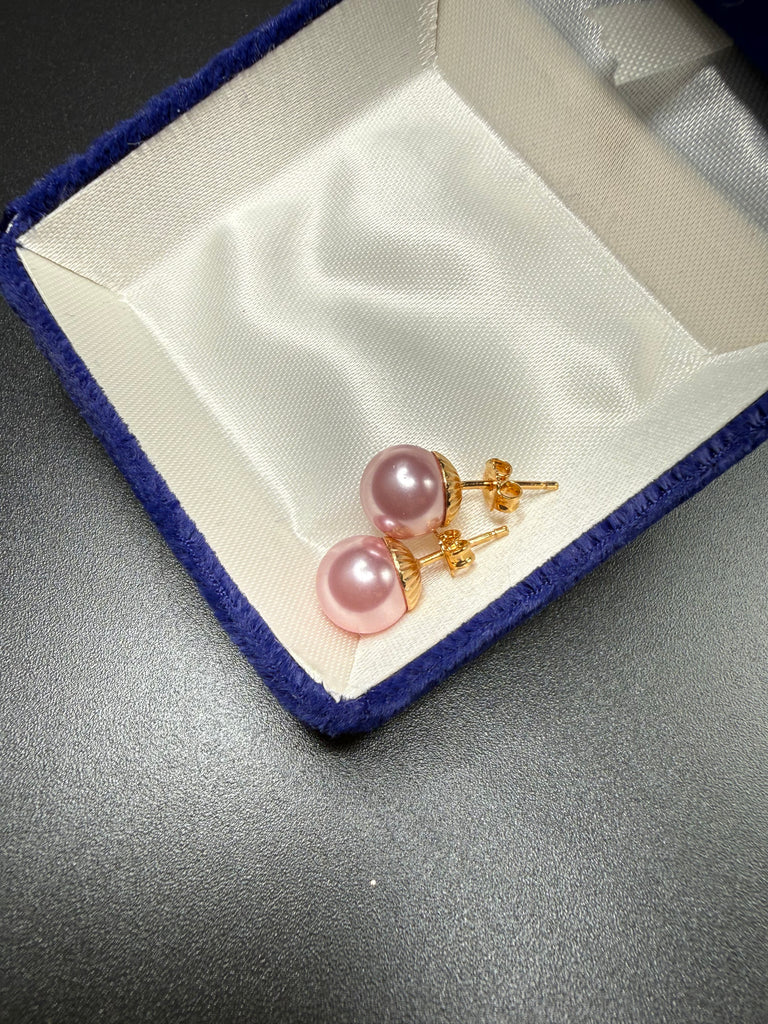 Back view of vintage pink faux pearl earrings showing gold-tone posts and butterfly backs