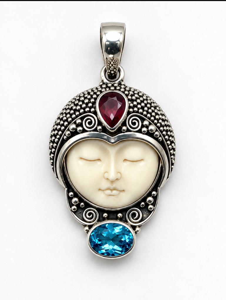 Front of vintage 925 silver face pendant with ornate granulation and red and blue stones