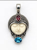 Front of vintage 925 silver face pendant with ornate granulation and red and blue stones