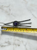 Long Lysgaard Design pewter pendant necklace shown beside measuring tape for scale