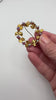Austrian Aurora Borealis crystal wreath brooch shown in hand for scale